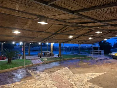 a large covered patio with lights on the ceiling at Villa Entrenaranjos in Picassent