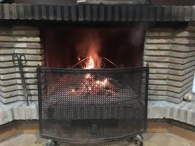 a fireplace with a fire inside of it at Villa Entrenaranjos in Picassent