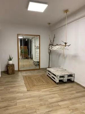a living room with a mirror and a table at Villa Entrenaranjos in Picassent