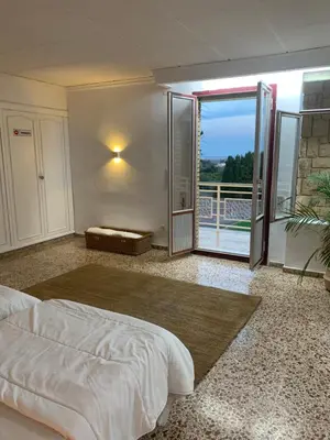 a bedroom with a bed and a sliding glass door at Villa Entrenaranjos in Picassent