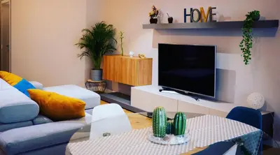 a living room with a couch and a tv at Hexagonal Design Apartment in Valencia