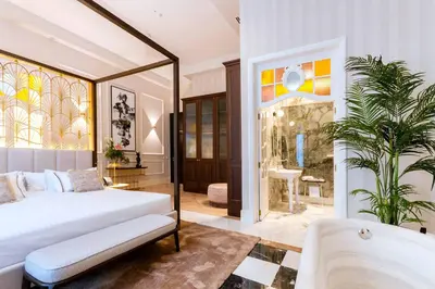 a bedroom with a bed and a large mirror at MYR Palacio Vallier in Valencia
