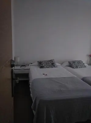 two twin beds in a room with at 7 Moons B&B in Valencia