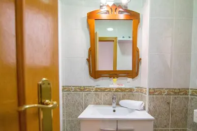 a bathroom with a sink and a mirror on the wall at Catedral Apartments in Valencia