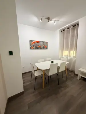 a white dining room with a white table and chairs at Zerka Sendra in Valencia