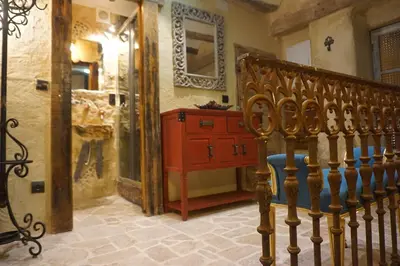 a room with a wooden staircase and a red dresser at CASA DEL ARTE casa rural in Chulilla