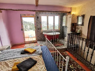 a bedroom with a bath tub and a bed at CASA DEL ARTE casa rural in Chulilla