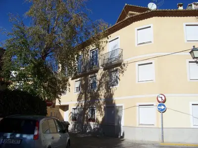 a building with a car parked in front of it at Apartamentos Chelo in Navajas