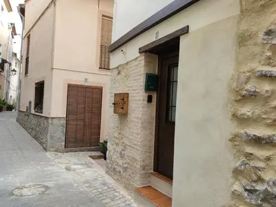 a building with a door on the side of a street at Casa Centro Jérica in Jérica