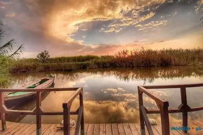 a boat sitting on a dock next to a lake at Hotel Manises in Manises