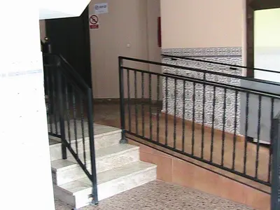 a staircase in a building with a black railing at Hotel Manises in Manises