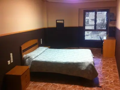 a bedroom with a bed and a window at Hotel Manises in Manises