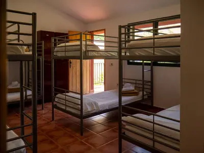 a room with four bunk beds in a room at El Cerrao-PauNatura in Sot de Chera