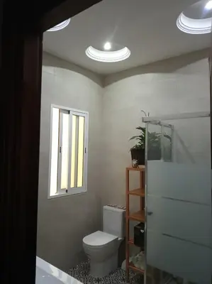 a bathroom with a toilet and a window at La Casa de los Espejos in Valencia