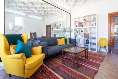 a living room with a couch and a table at La Casa de los Espejos in Valencia