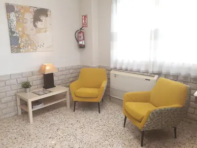 a waiting room with two chairs and a table at Hostal Moreno in Silla