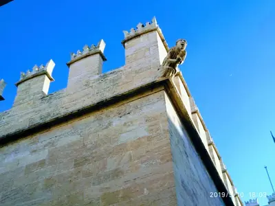 a building with a gargoyle on top of it at Valencian Dreams Lonja in Valencia
