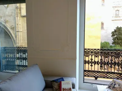 a couch in front of a window with a view at Valencian Dreams Lonja in Valencia