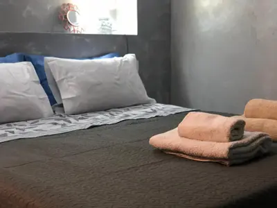 a bed with two towels and pillows on it at Partenopeo 26 in Valencia