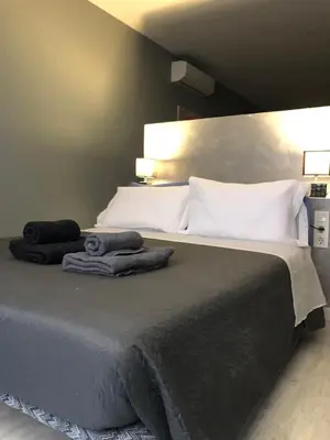 a bedroom with a large bed with towels on it at Partenopeo 26 in Valencia