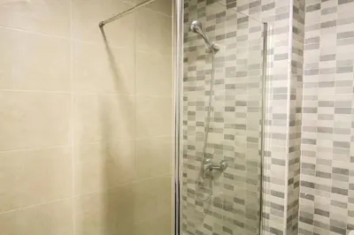 a shower with a glass door in a bathroom at Partenopeo 26 in Valencia