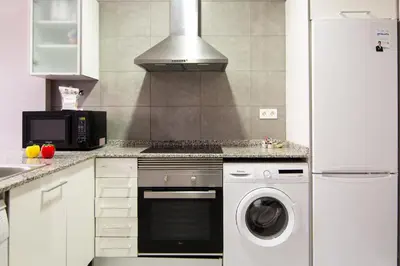a kitchen with a washer and a stove top oven at Partenopeo 26 in Valencia