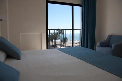 a bedroom with a bed and a window with a view at Hotel Sicania in Cullera