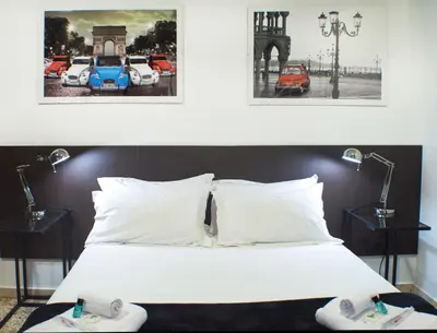 a bedroom with a white bed with two lamps at Quart Youth Hostel & Apartments in Valencia