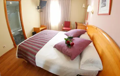 a hotel room with a large bed with pillows at Maria de Luna in Segorbe