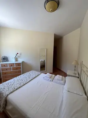 a bedroom with a white bed with two towels on it at Apartamento Casa Rafa in Navajas