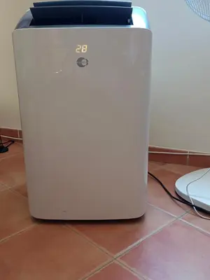 a white refrigerator sitting on a tile floor at Apartamento Casa Rafa in Navajas