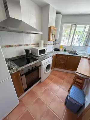 a kitchen with a sink and a stove top oven at Apartamento Casa Rafa in Navajas