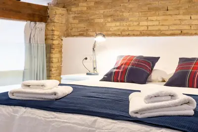 a bedroom with a bed with towels on it at ANELSA Apmts DESCUBRE VALENCIA Y SU PLAYA in Valencia