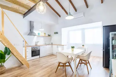 a kitchen and dining room with a table and chairs at ANELSA Apmts DESCUBRE VALENCIA Y SU PLAYA in Valencia