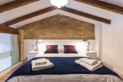 a bedroom with a large bed with two lamps at ANELSA Apmts DESCUBRE VALENCIA Y SU PLAYA in Valencia