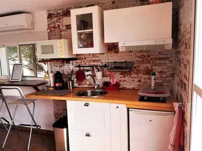 a kitchen with white cabinets and a sink at CASA MARTINEZ MONTROY à 3 kms de MONTSERRAT VALENCIA in Montroy