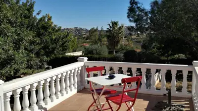 a table and two chairs on a balcony at CASA MARTINEZ MONTROY à 3 kms de MONTSERRAT VALENCIA in Montroy