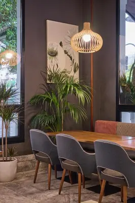 a dining room with a wooden table and chairs at Hotel Malcom and Barret in Valencia
