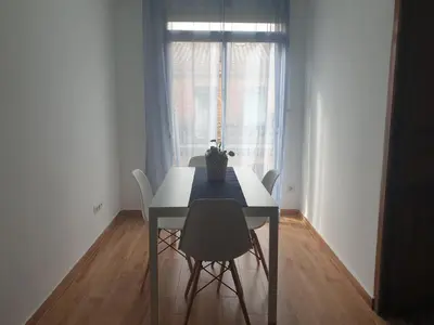 a table and chairs in a room with a window at Sofia's Flat in Valencia