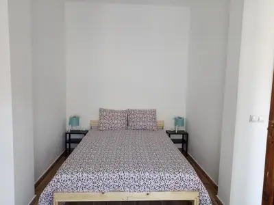 a bed in a room with two night stands at Sofia's Flat in Valencia