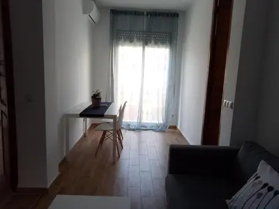 a living room with a table and a window at Sofia's Flat in Valencia