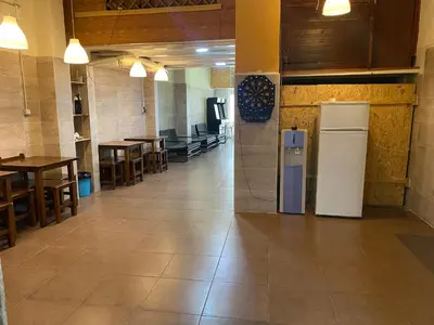 an empty restaurant with a refrigerator and tables and chairs at better Oh! in Valencia