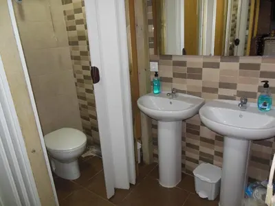 a bathroom with two sinks and a toilet at better Oh! in Valencia