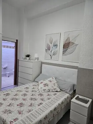 a bedroom with a bed and two pictures on the wall at Habitacion en casa de familia 