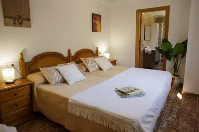 a bedroom with a bed with a book on it at Casa Ramos in Navarrés