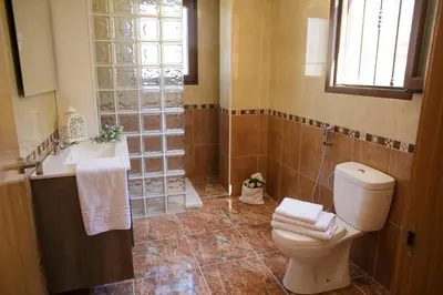a bathroom with a toilet and a sink at Casa Ramos in Navarrés