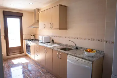 a kitchen with a sink and a dishwasher at Casa Ramos in Navarrés