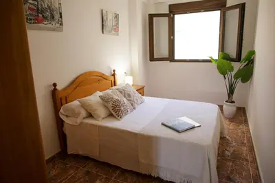 a bedroom with a bed with a book on it at Casa Ramos in Navarrés