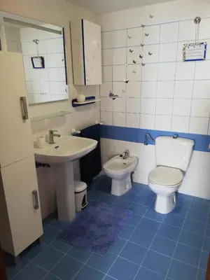 a bathroom with a toilet and a sink at IDEALLY located on BEACH in Port Saplaya