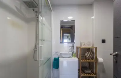 a white bathroom with a shower and a sink at Sea view Port Saplaya Apartments,2 in Port Saplaya
